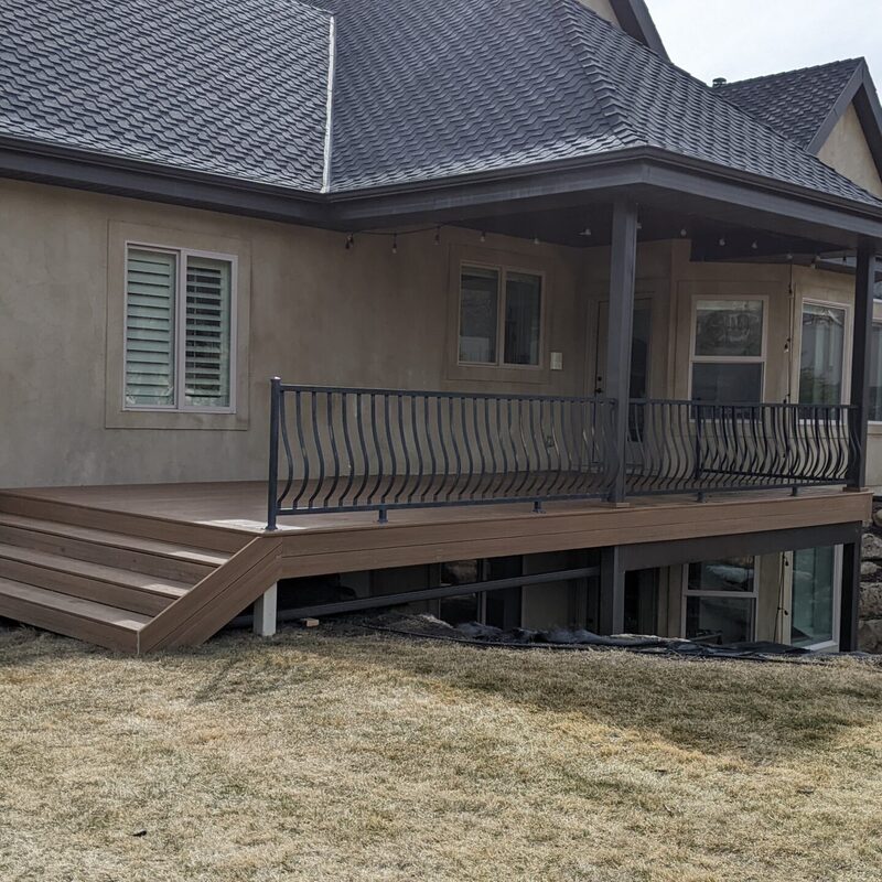 Expand your outdoor living space with this custom deck project by DeckPro LLC, designed to blend rustic charm with modern durability. This build features low-maintenance composite decking and a unique perimeter railing that combines natural wood posts with wire mesh infill panels. The functional design includes extensive built-in bench seating, making it an inviting retreat perfect for relaxing and taking in scenic, natural views.