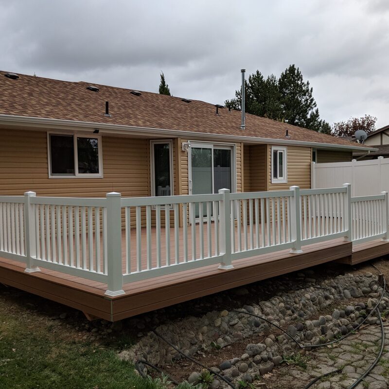 Create a beautiful and durable outdoor living space with a custom composite deck from DeckPro LLC. This project pairs rich brown composite decking with clean white vinyl railing for a classic, low-maintenance look that perfectly complements the home's siding and provides a great space for relaxation.