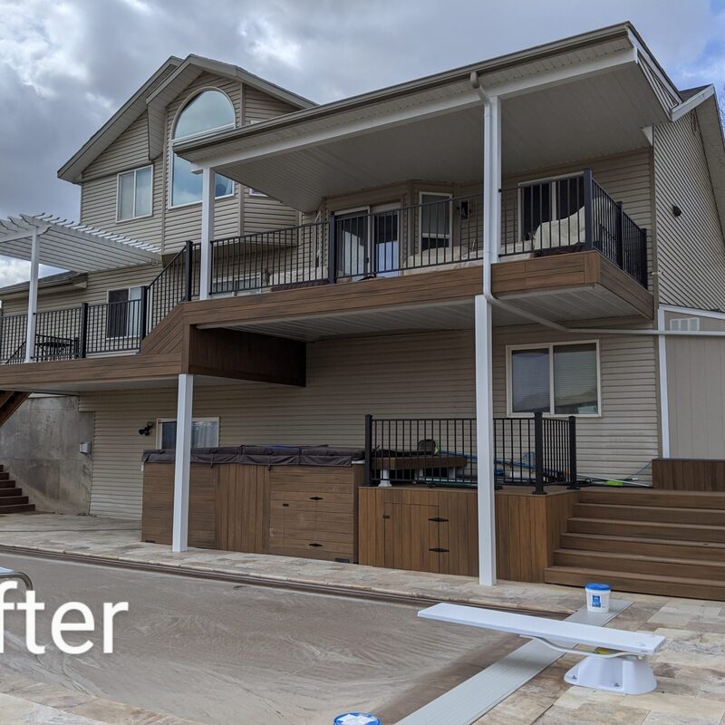 Expand your outdoor living possibilities with this extensive multi-level deck project by DeckPro LLC, pictured here in a transition from winter to spring. This sturdy design integrates seamlessly with the unique stucco and brick architecture of the home, featuring durable, low-maintenance composite decking in a modern grey tone. We installed sophisticated dark metal perimeter railings and matching grey post sleeves for a sleek, contemporary feel. Pictured on a sunny day with distinct railing shadows, the vast structure transitions smoothly down to a lower concrete level, creating defined areas for sun and shade and optimizing panoramic natural views.