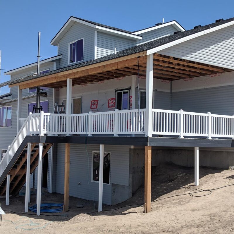 Are you dreaming of a beautiful and functional outdoor living space? At DeckPro LLC, we specialize in creating stunning custom decks that enhance the value and enjoyment of your home. This image showcases a recent project in Sandy, Utah, where we transformed a challenging slope into a multi-level deck featuring composite decking, vinyl railings, and a charming covered patio area.